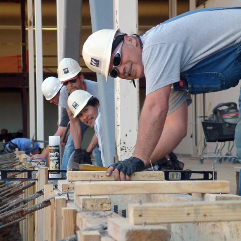 crain construction workers posing while working