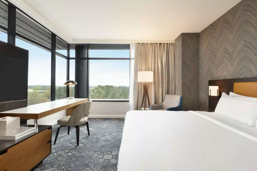 hilton alpharetta hotel room with king bed open windows