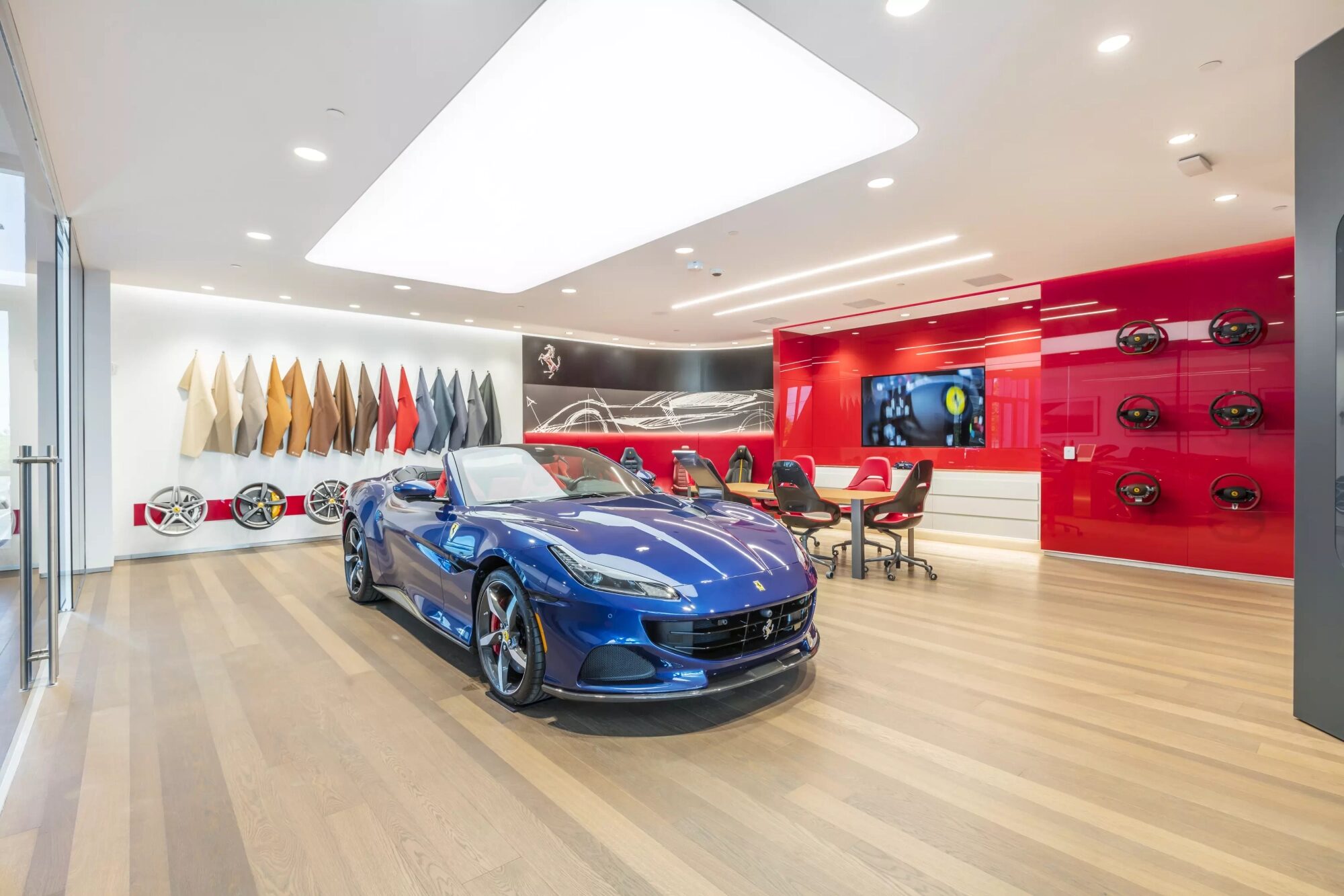 blue ferrari on display at dealership
