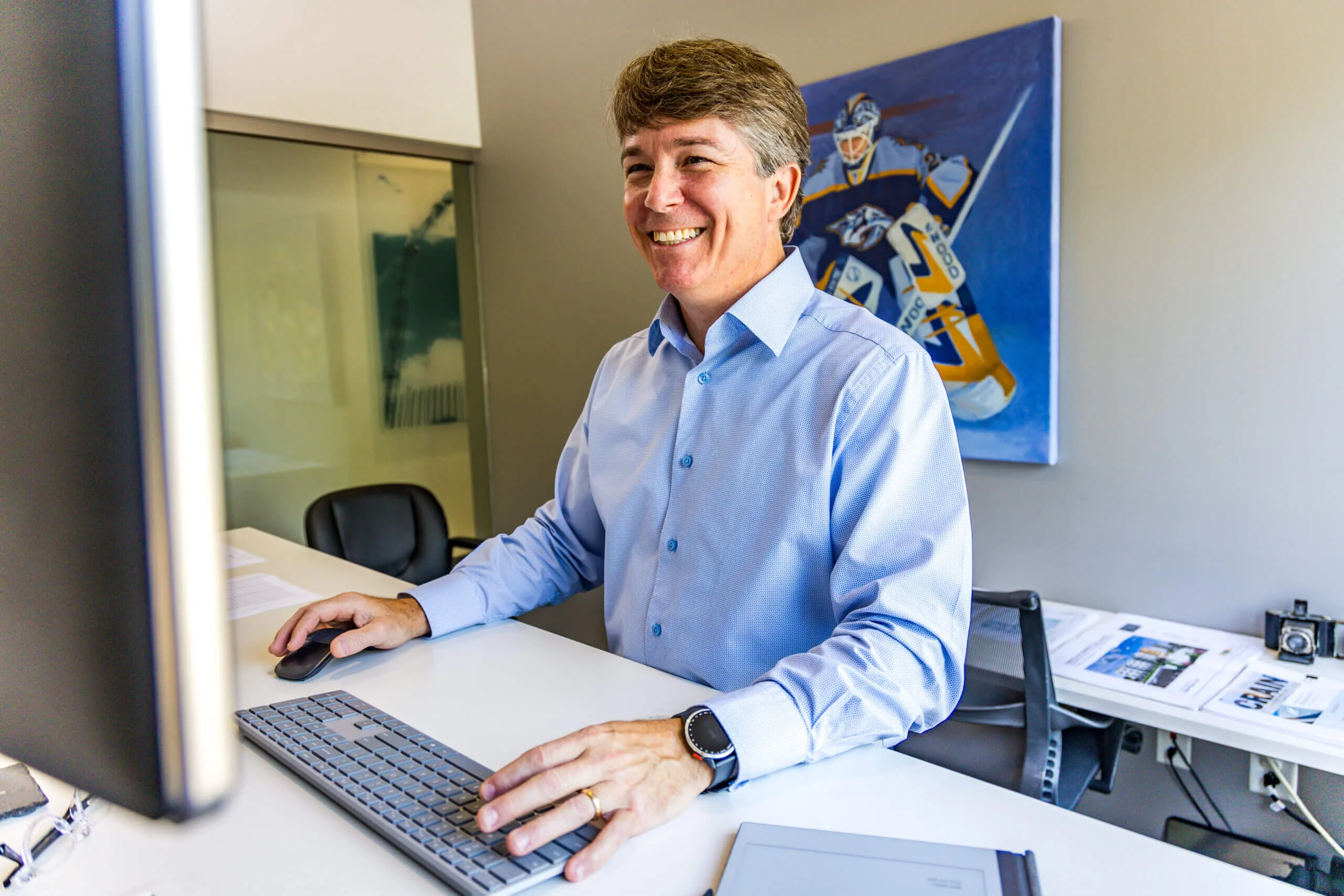crain construction employee standing at office desk