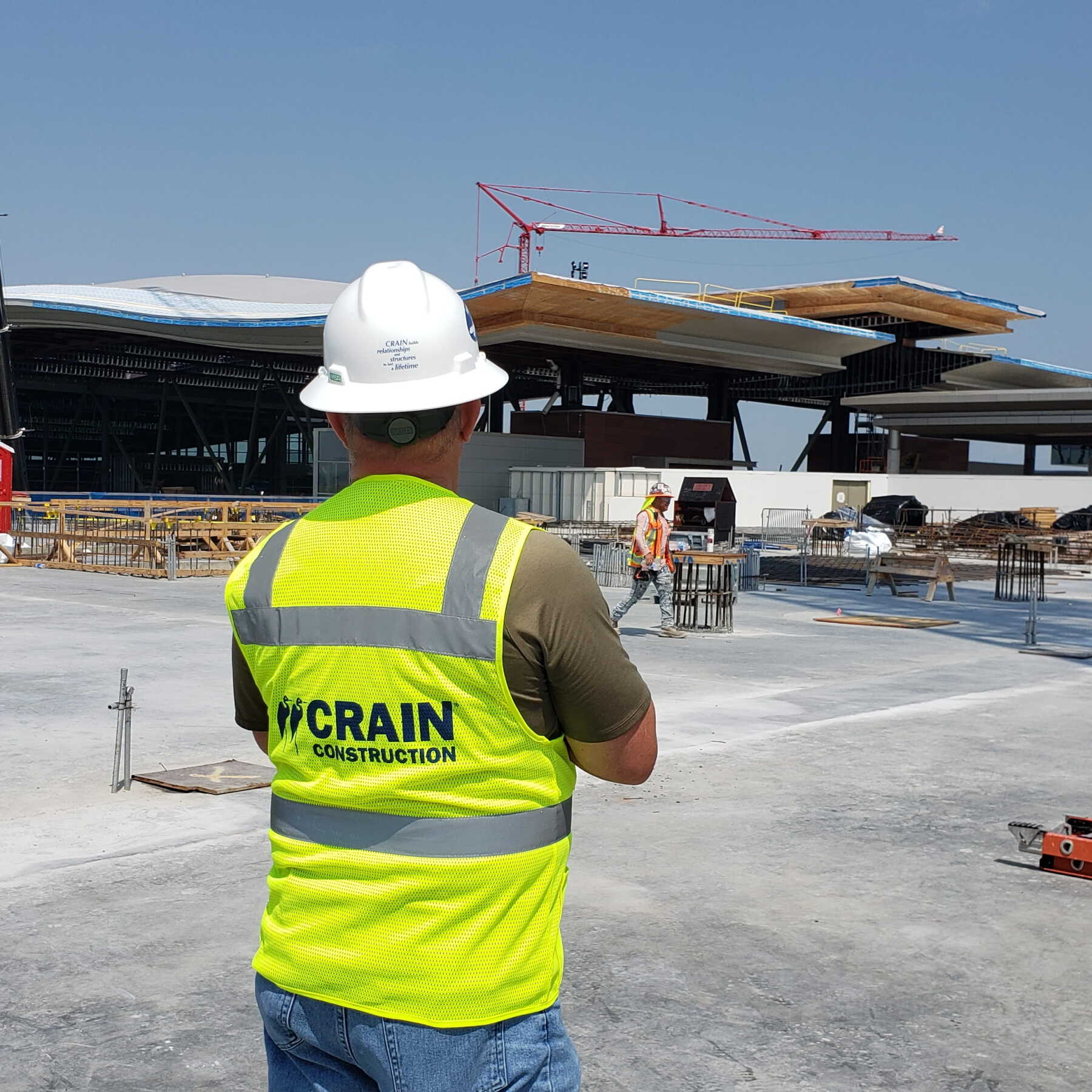 crain construction employee wearing vest on construction site